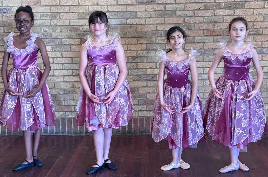Junior ballet pupils in pink and lilac performance dresses at Karen Chapman School of Dancing