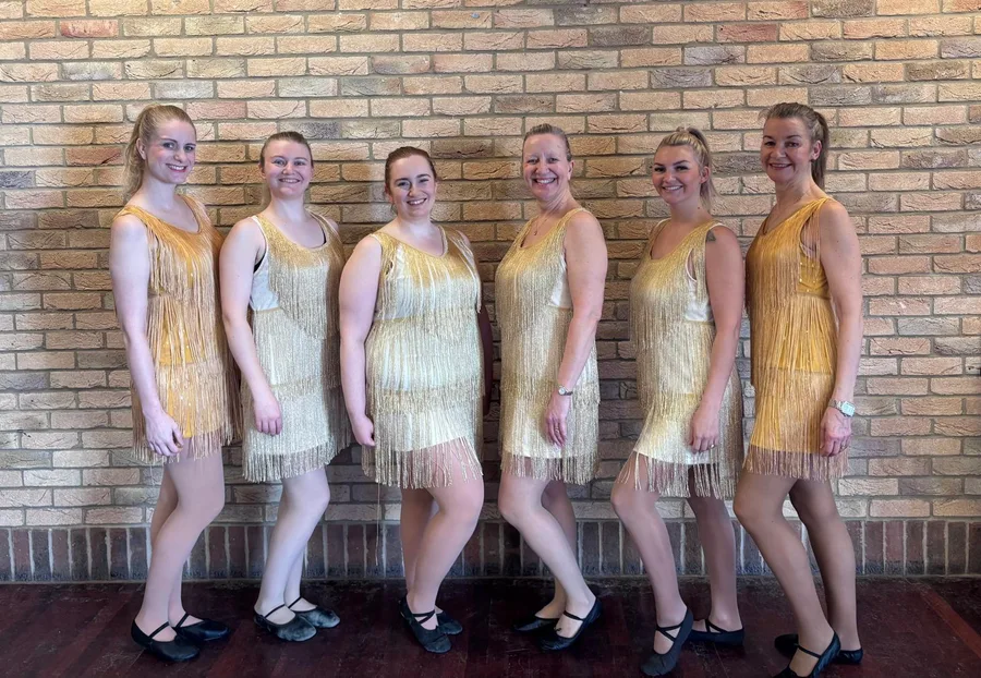 Adult tap class in gold fringed flapper dresses at Karen Chapman School of Dancing in Harlow