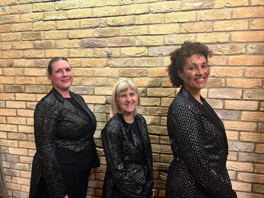 Adult dance class members in black sequinned jackets at Karen Chapman School of Dancing